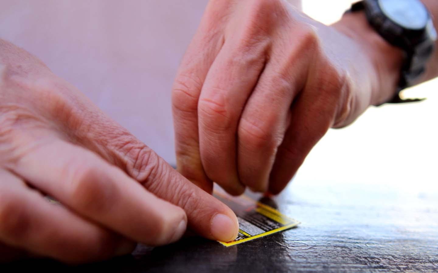 man using a scratch card